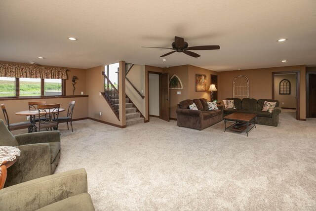 2238 Marvs Ln NE, Stewartville, MN 55976 - living room with stairs, light colored carpet, recessed lighting, ceiling fan, and baseboards