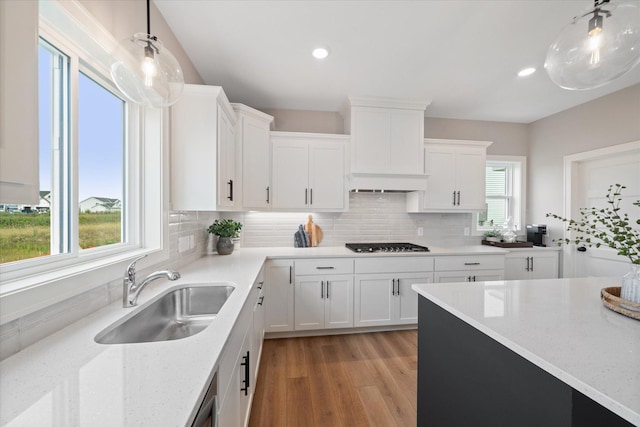 4980 Kyla Way SE, Prior Lake, MN 55372 - kitchen with tasteful backsplash, light wood-style flooring, white cabinets, hanging light fixtures, and recessed lighting
