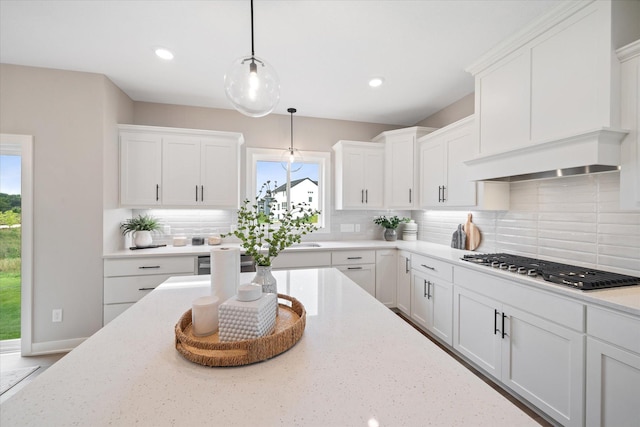 4980 Kyla Way SE, Prior Lake, MN 55372 - kitchen with stainless steel gas stovetop, plenty of natural light, white cabinets, tasteful backsplash, and recessed lighting