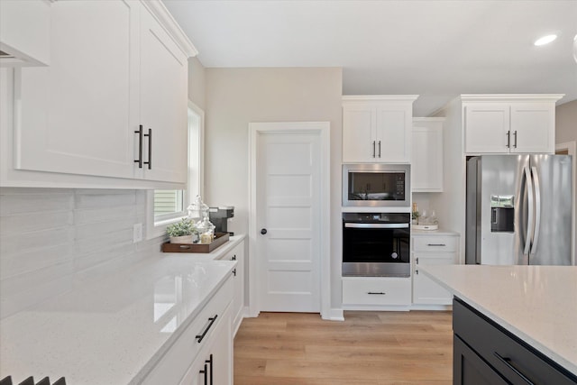 4980 Kyla Way SE, Prior Lake, MN 55372 - kitchen with stainless steel appliances, light wood-style flooring, white cabinetry, light stone countertops, and recessed lighting