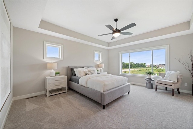 4980 Kyla Way SE, Prior Lake, MN 55372 - bedroom featuring a tray ceiling, light colored carpet, and ceiling fan