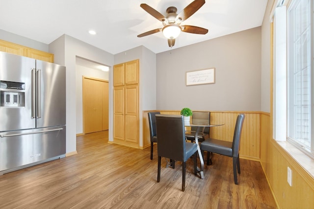 6103 150th St N, Hugo, MN 55038 - dining room featuring light wood-style floors, a ceiling fan, and wainscoting