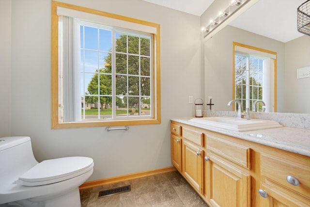 6103 150th St N, Hugo, MN 55038 - bathroom with baseboards, vanity, and toilet