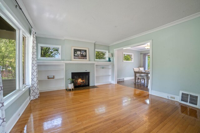 5232 Tioga St, Duluth, MN 55804 - living room with hardwood / wood-style floors, ornamental molding, a fireplace, and baseboards