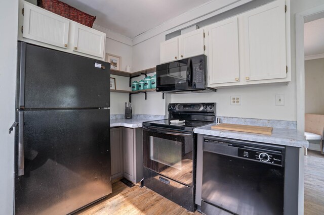 5232 Tioga St, Duluth, MN 55804 - kitchen featuring black appliances, crown molding, light wood finished floors, light countertops, and white cabinets