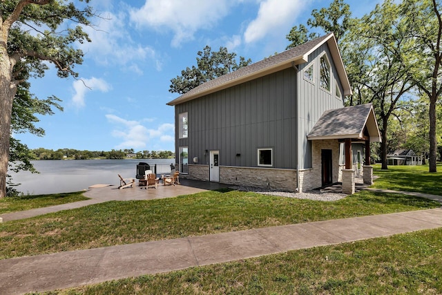 565 Brooks Lake Rd NW, Cokato, MN 55321 - view of property exterior with a shingled roof, board and batten siding, a patio, and a yard