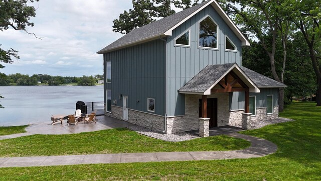 565 Brooks Lake Rd NW, Cokato, MN 55321 - view of front of property with roof with shingles, stone siding, a patio, and a front lawn