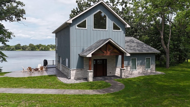 565 Brooks Lake Rd NW, Cokato, MN 55321 - view of front of property with stone siding, roof with shingles, a front lawn, a patio area, and board and batten siding