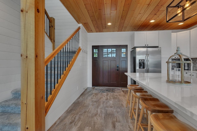 565 Brooks Lake Rd NW, Cokato, MN 55321 - entrance foyer featuring wood ceiling, stairway, wood walls, light wood-style flooring, and recessed lighting