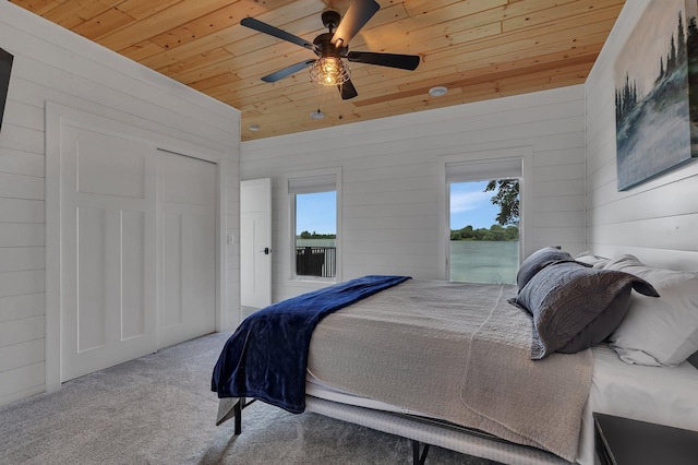 565 Brooks Lake Rd NW, Cokato, MN 55321 - carpeted bedroom with wooden ceiling, wood walls, ceiling fan, and access to outside