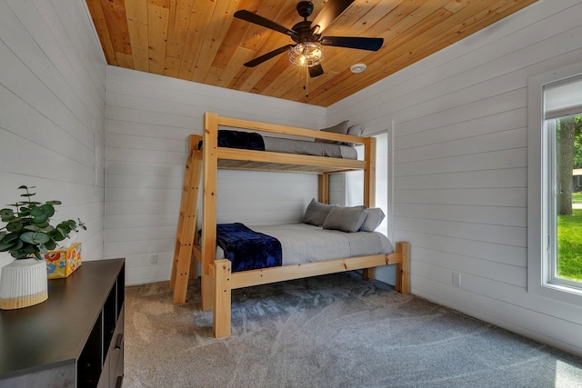 565 Brooks Lake Rd NW, Cokato, MN 55321 - bedroom featuring wooden walls, carpet floors, multiple windows, wooden ceiling, and ceiling fan