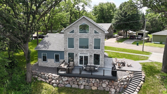 565 Brooks Lake Rd NW, Cokato, MN 55321 - rear view of property with a fire pit, stone siding, a patio area, and a yard