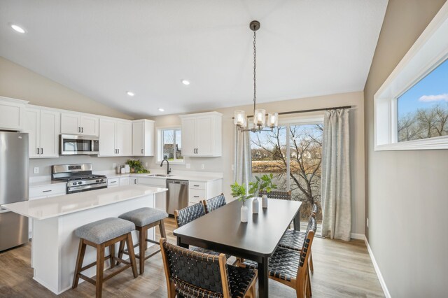 129 Terning Way, Howard Lake, MN 55349 - dining space featuring lofted ceiling, a chandelier, light wood finished floors, recessed lighting, and baseboards