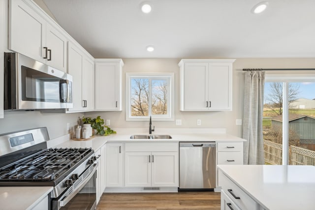 129 Terning Way, Howard Lake, MN 55349 - kitchen featuring appliances with stainless steel finishes, a sink, light countertops, white cabinetry, and recessed lighting