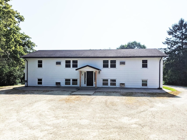 1101 Spring Creek Rd, Northfield, MN 55057 - bi-level home featuring a patio and roof with shingles