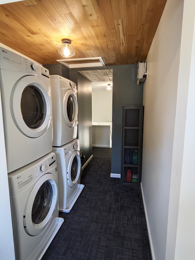 1101 Spring Creek Rd, Northfield, MN 55057 - laundry area featuring stacked washer / dryer, wooden ceiling, dark colored carpet, and baseboards