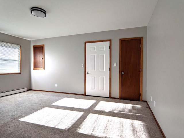 1101 Spring Creek Rd, Northfield, MN 55057 - unfurnished bedroom featuring carpet, baseboards, and baseboard heating