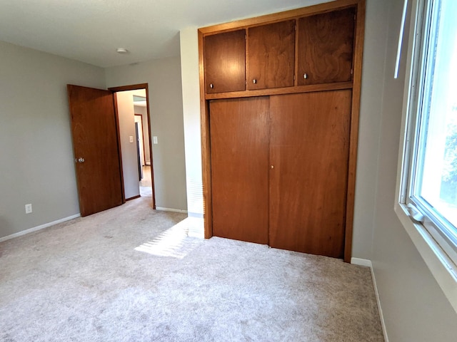 1101 Spring Creek Rd, Northfield, MN 55057 - unfurnished bedroom with light carpet, a closet, and baseboards