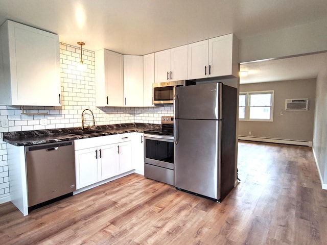1101 Spring Creek Rd, Northfield, MN 55057 - kitchen with stainless steel appliances, a sink, a baseboard radiator, and white cabinets