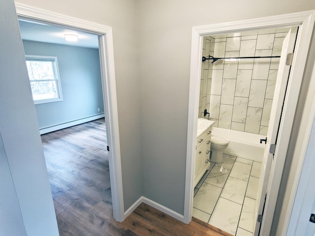 1101 Spring Creek Rd, Northfield, MN 55057 - full bathroom with a baseboard heating unit, vanity, baseboards, toilet, and shower / washtub combination