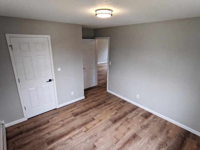 1101 Spring Creek Rd, Northfield, MN 55057 - unfurnished bedroom featuring baseboards and wood finished floors