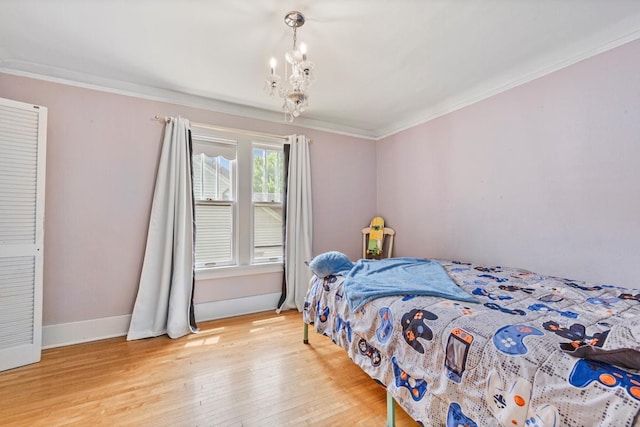 407 4th Ave SW, Faribault, MN 55021 - bedroom featuring ornamental molding, light wood finished floors, and a chandelier