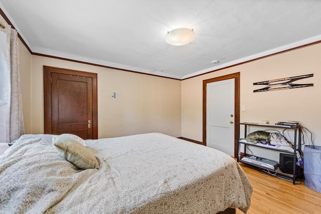 407 4th Ave SW, Faribault, MN 55021 - bedroom featuring light wood finished floors and ornamental molding