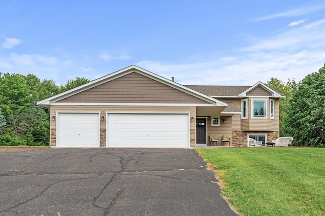 18125 Fillmore St NE, East Bethel, MN 55011 - tri-level home with asphalt driveway, a front yard, stone siding, and a garage