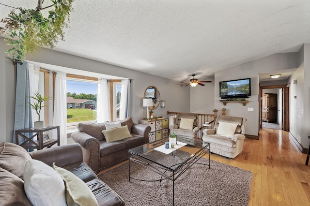 18125 Fillmore St NE, East Bethel, MN 55011 - living area with light wood-type flooring, a textured ceiling, ceiling fan, and lofted ceiling