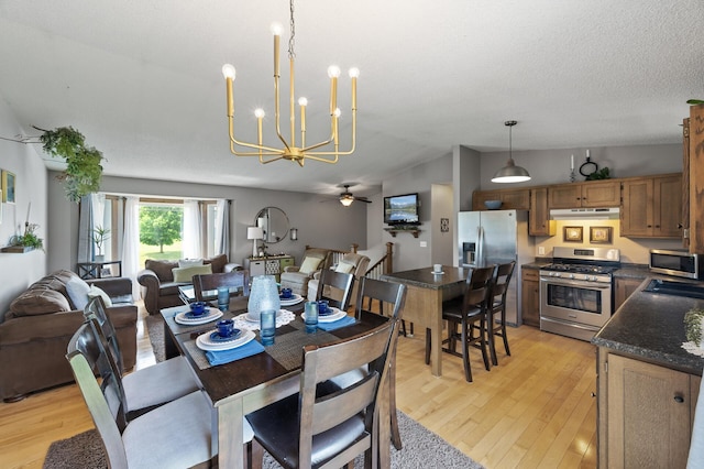 18125 Fillmore St NE, East Bethel, MN 55011 - dining space with light wood-style flooring, lofted ceiling, a chandelier, and a ceiling fan