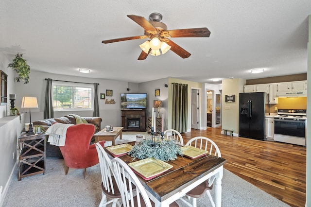 18125 Fillmore St NE, East Bethel, MN 55011 - dining room with ceiling fan, a glass covered fireplace, and wood finished floors