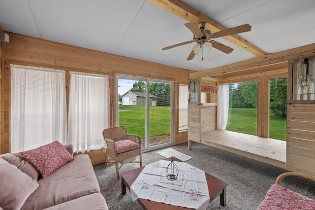 18125 Fillmore St NE, East Bethel, MN 55011 - living room featuring wood walls, a ceiling fan, and carpet