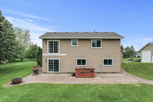 18125 Fillmore St NE, East Bethel, MN 55011 - rear view of property with a hot tub, a patio, an outdoor fire pit, and a lawn