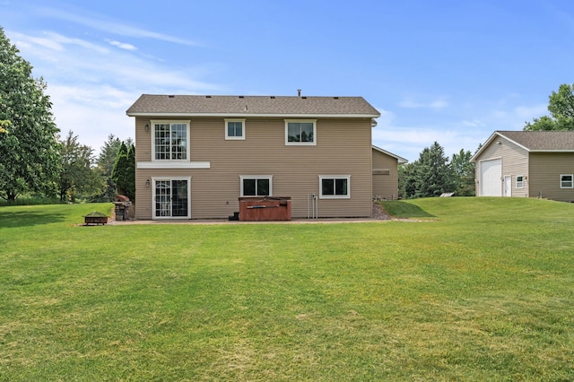 18125 Fillmore St NE, East Bethel, MN 55011 - back of house featuring a hot tub, an outdoor fire pit, a yard, and a patio area