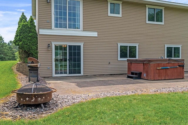 18125 Fillmore St NE, East Bethel, MN 55011 - back of property with a hot tub, a fire pit, and a patio area