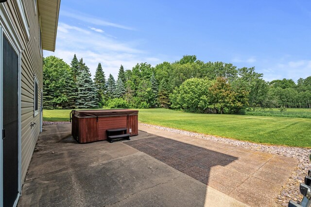 18125 Fillmore St NE, East Bethel, MN 55011 - view of patio / terrace with a hot tub and a wooded view