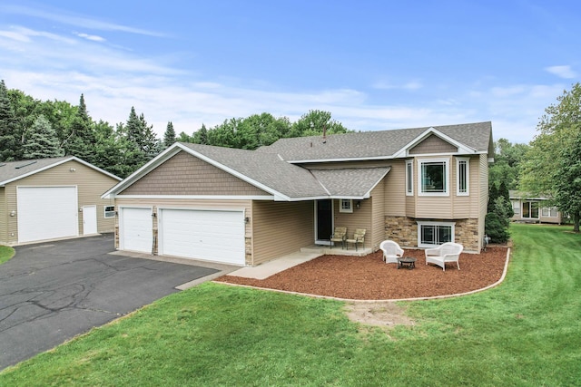 18125 Fillmore St NE, East Bethel, MN 55011 - tri-level home featuring stone siding, a front yard, driveway, a garage, and roof with shingles