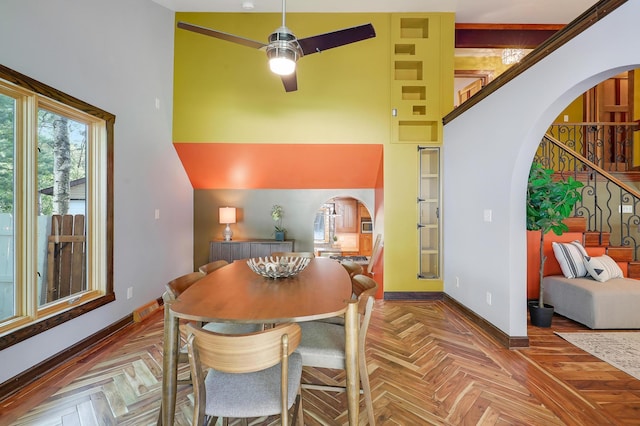 1919 Timberline Spur, Minnetonka, MN 55305 - dining room featuring a ceiling fan, arched walkways, stairway, and a high ceiling