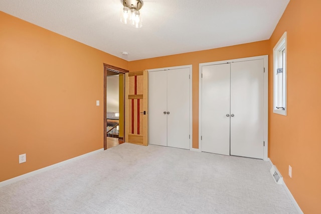 1919 Timberline Spur, Minnetonka, MN 55305 - unfurnished bedroom with multiple closets and carpet floors