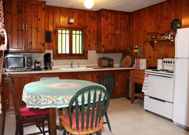 32704 310th Ln, Aitkin, MN 56431 - kitchen with white appliances, a sink, light countertops, brown cabinets, and tasteful backsplash