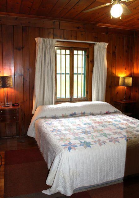 32704 310th Ln, Aitkin, MN 56431 - bedroom with wooden ceiling, wood walls, ceiling fan, and wood finished floors