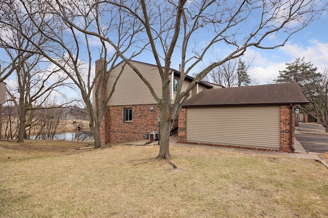 2436 Mendelssohn Ln N, Golden Valley, MN 55427 - view of property exterior featuring brick siding, a lawn, a chimney, and a water view