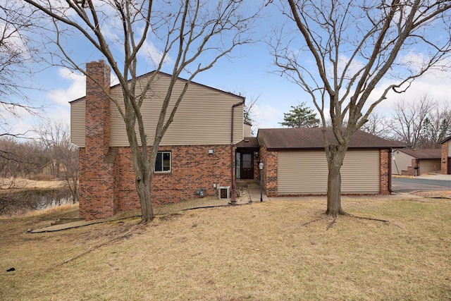 2436 Mendelssohn Ln N, Golden Valley, MN 55427 - view of home's exterior featuring brick siding, a chimney, and a lawn