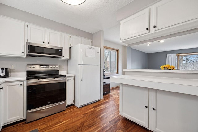 2436 Mendelssohn Ln N, Golden Valley, MN 55427 - kitchen featuring stainless steel appliances, healthy amount of natural light, white cabinets, and light countertops