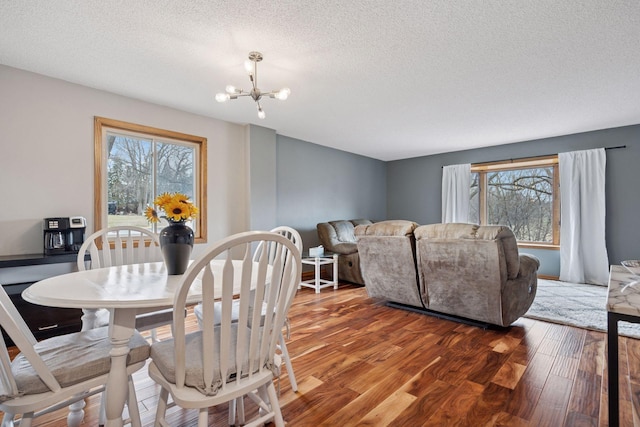 2436 Mendelssohn Ln N, Golden Valley, MN 55427 - dining room with wood finished floors, plenty of natural light, a textured ceiling, and a chandelier
