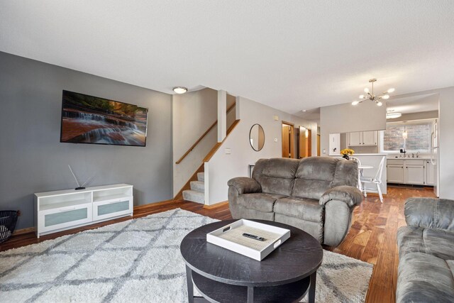 2436 Mendelssohn Ln N, Golden Valley, MN 55427 - living area featuring stairway, light wood-style flooring, and a chandelier