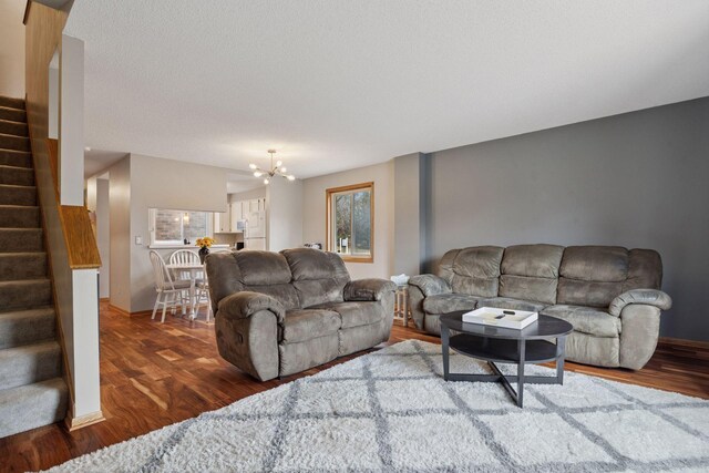 2436 Mendelssohn Ln N, Golden Valley, MN 55427 - living area with stairs, a chandelier, wood finished floors, and baseboards