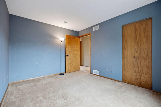 2436 Mendelssohn Ln N, Golden Valley, MN 55427 - unfurnished bedroom featuring carpet flooring, a closet, and baseboards