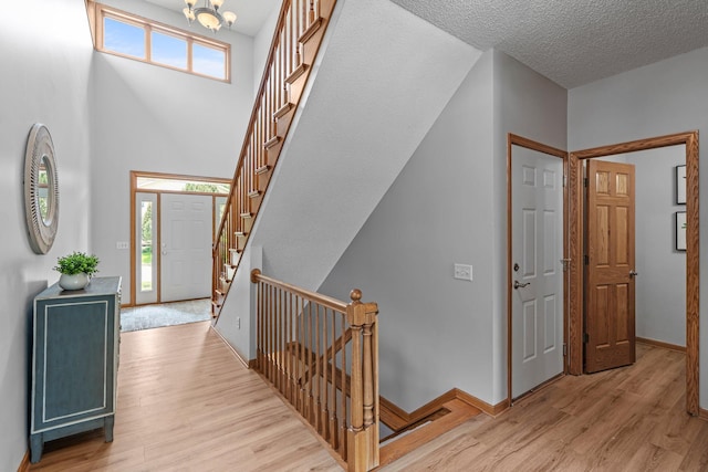 3868 Green Heights Trl SW, Prior Lake, MN 55372 - foyer with light wood finished floors, stairway, and a chandelier