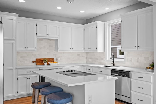3868 Green Heights Trl SW, Prior Lake, MN 55372 - kitchen with dishwasher, white cabinetry, black electric stovetop, light countertops, and a kitchen island